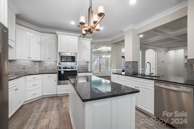 kitchen featuring appliances with stainless steel finishes, white cabinetry, sink, a notable chandelier, and coffered ceiling