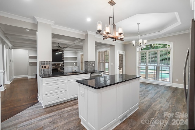 kitchen with white cabinets, sink, crown molding, and coffered ceiling