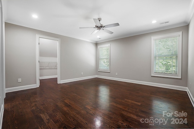 spare room with ceiling fan, dark hardwood / wood-style flooring, ornamental molding, and a healthy amount of sunlight