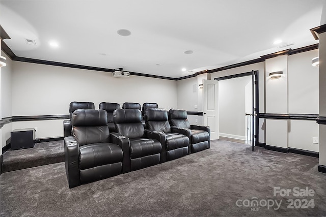 home theater featuring crown molding and dark colored carpet