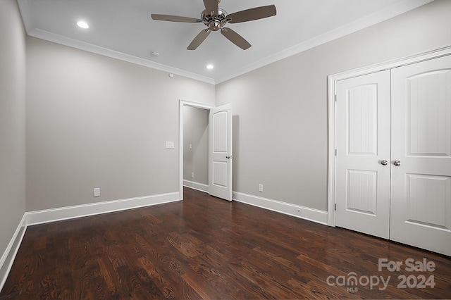 unfurnished bedroom featuring ceiling fan, dark hardwood / wood-style floors, a closet, and crown molding