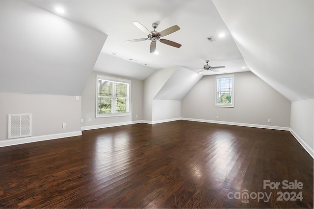 additional living space featuring ceiling fan, dark hardwood / wood-style flooring, and vaulted ceiling