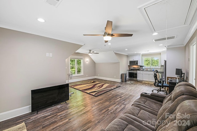 living room with lofted ceiling, wood-type flooring, plenty of natural light, and ornamental molding