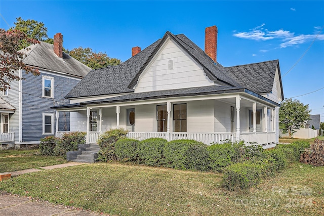 view of front of home with a porch and a front yard