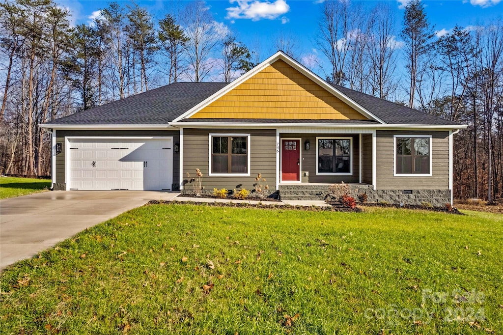 single story home with a garage and a front yard