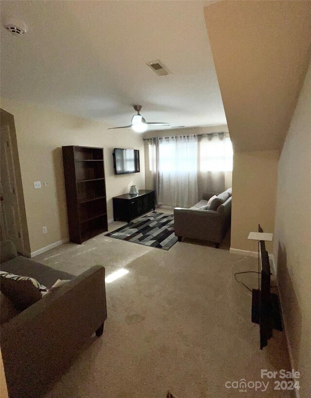 living room featuring carpet and ceiling fan