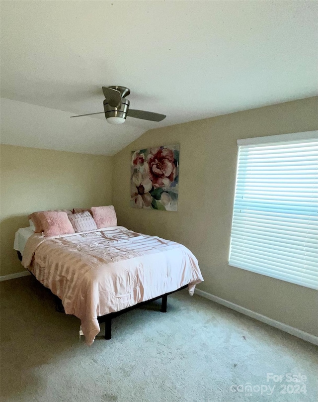 bedroom with ceiling fan, carpet floors, and lofted ceiling