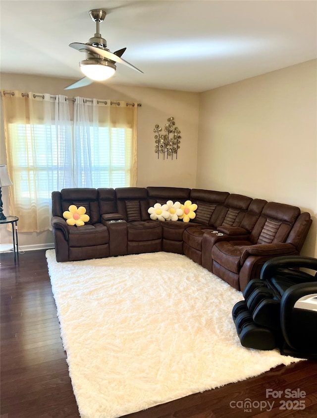 living area featuring dark wood-style floors and a ceiling fan