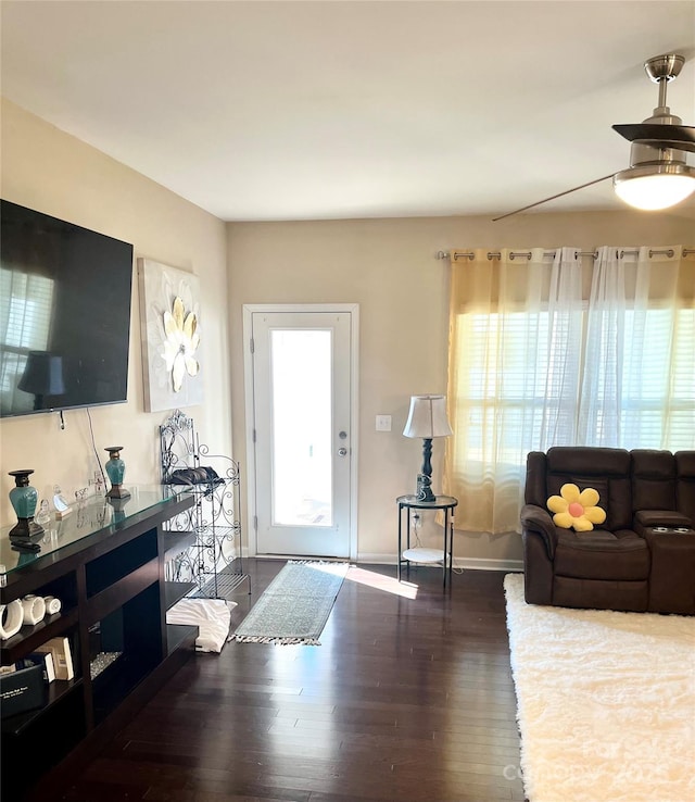 living area with wood finished floors and baseboards