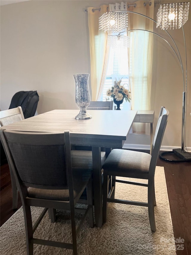 dining area featuring baseboards and wood finished floors