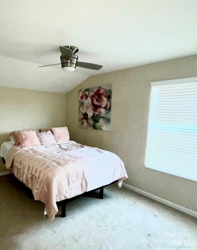 bedroom featuring lofted ceiling, carpet, baseboards, and ceiling fan