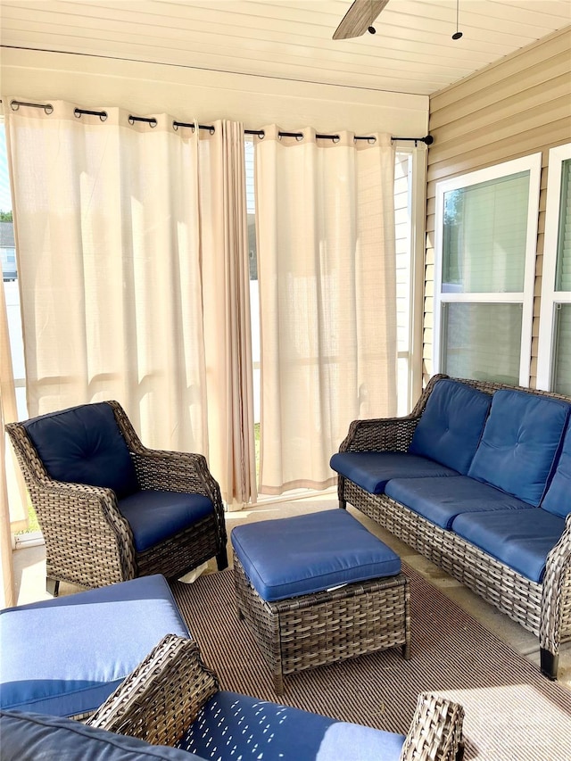 sunroom / solarium featuring wooden ceiling and ceiling fan