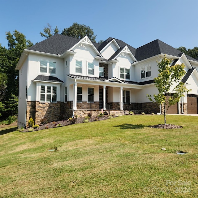 craftsman house featuring a front lawn and covered porch