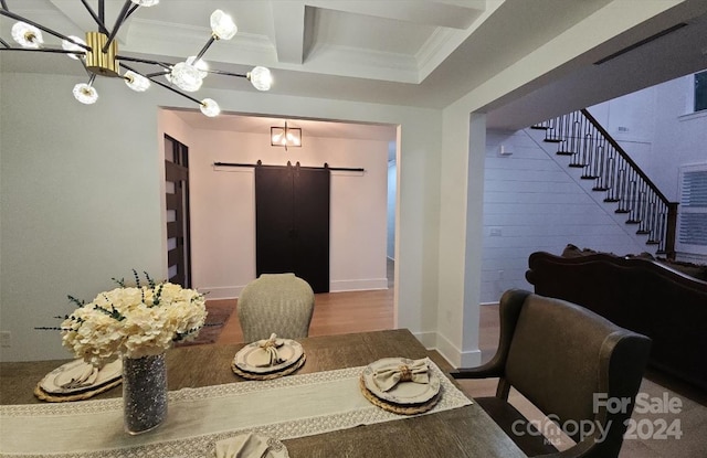 dining space featuring hardwood / wood-style flooring, beamed ceiling, crown molding, a barn door, and a chandelier