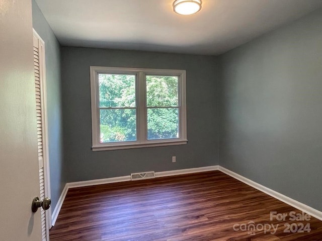 empty room featuring dark hardwood / wood-style flooring