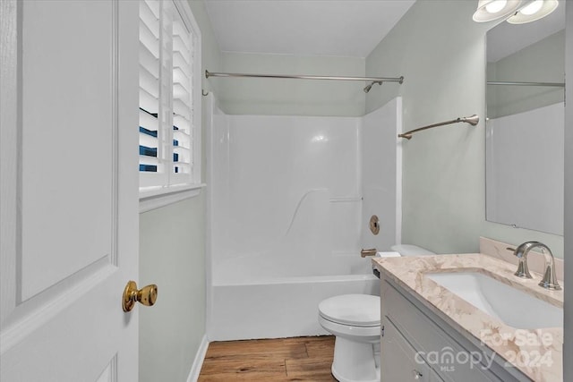 full bathroom with vanity, shower / bathtub combination, toilet, and wood-type flooring