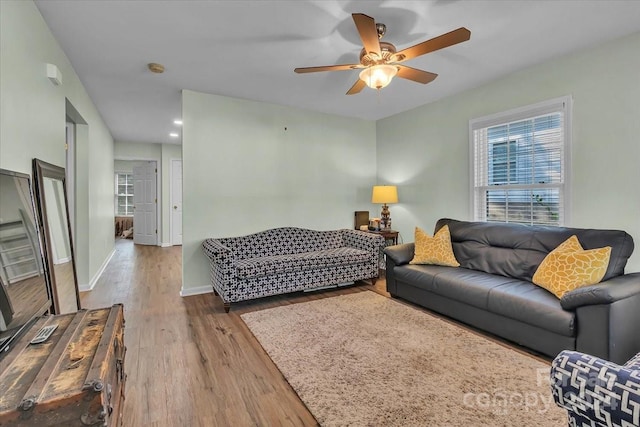 living room with ceiling fan and light hardwood / wood-style floors