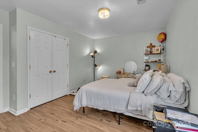 bedroom featuring light hardwood / wood-style floors and a closet