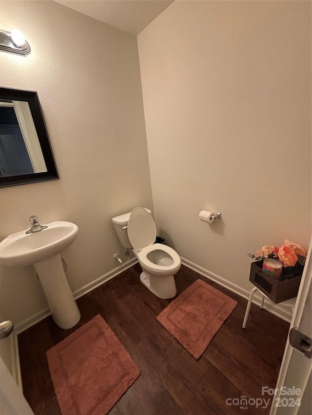 bathroom featuring hardwood / wood-style flooring and toilet