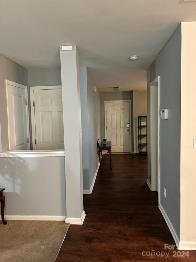 hallway with dark hardwood / wood-style floors