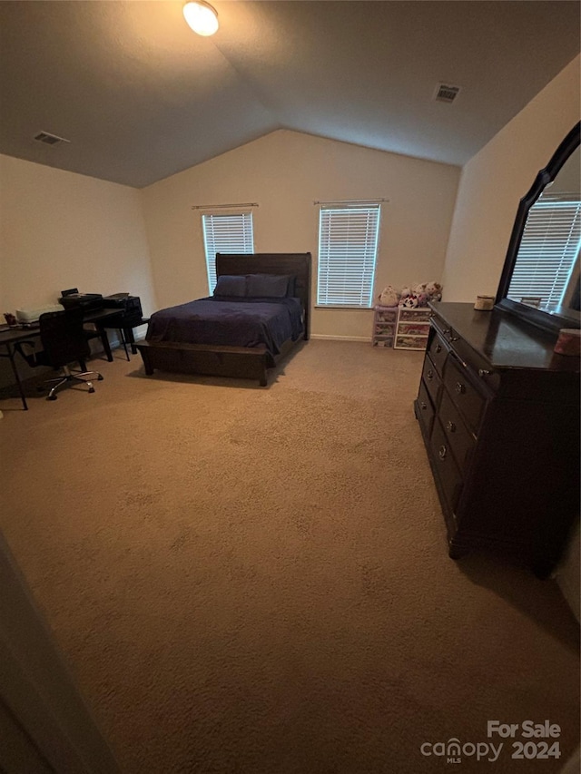 bedroom featuring lofted ceiling and light carpet