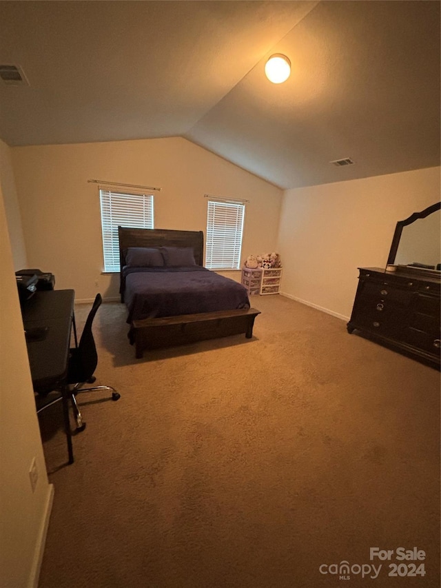 bedroom featuring carpet flooring and lofted ceiling