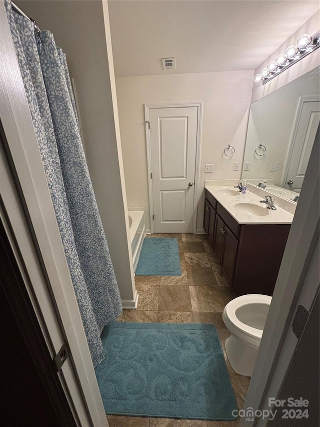 bathroom featuring a tub and vanity