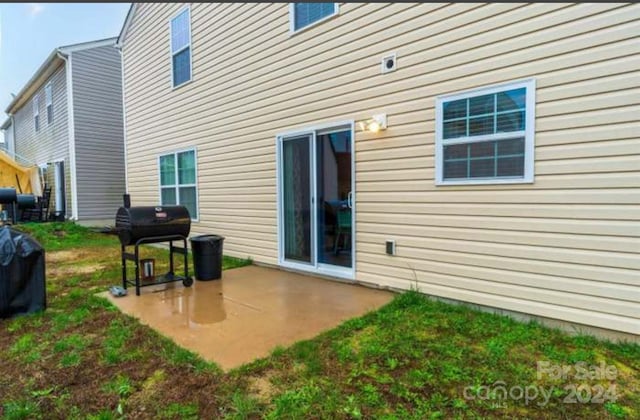 rear view of property with a yard and a patio