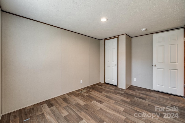 unfurnished bedroom with wood-type flooring and a textured ceiling