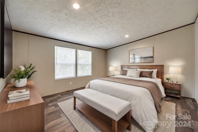 bedroom with dark wood-type flooring and a textured ceiling