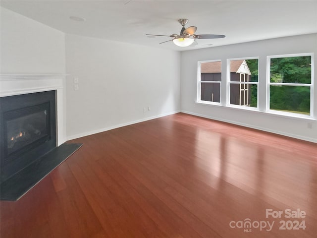 unfurnished living room with hardwood / wood-style floors and ceiling fan