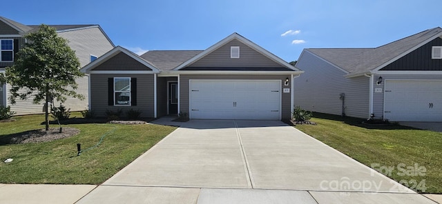 view of front of house with a garage and a front lawn