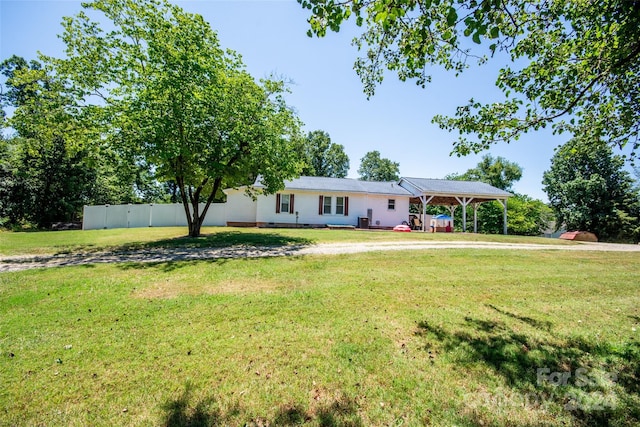 ranch-style house featuring a wooden deck and a front lawn