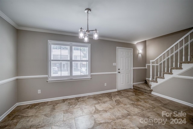 foyer entrance with an inviting chandelier and ornamental molding