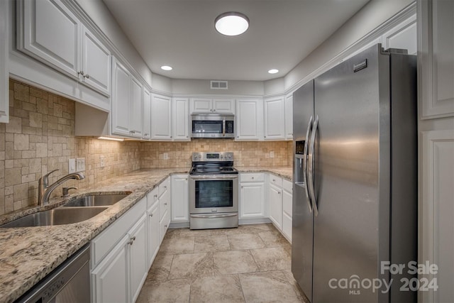 kitchen with white cabinets, stainless steel appliances, and sink