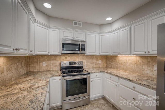 kitchen with appliances with stainless steel finishes and white cabinetry