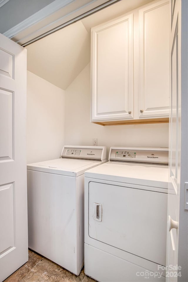 washroom with cabinets and separate washer and dryer