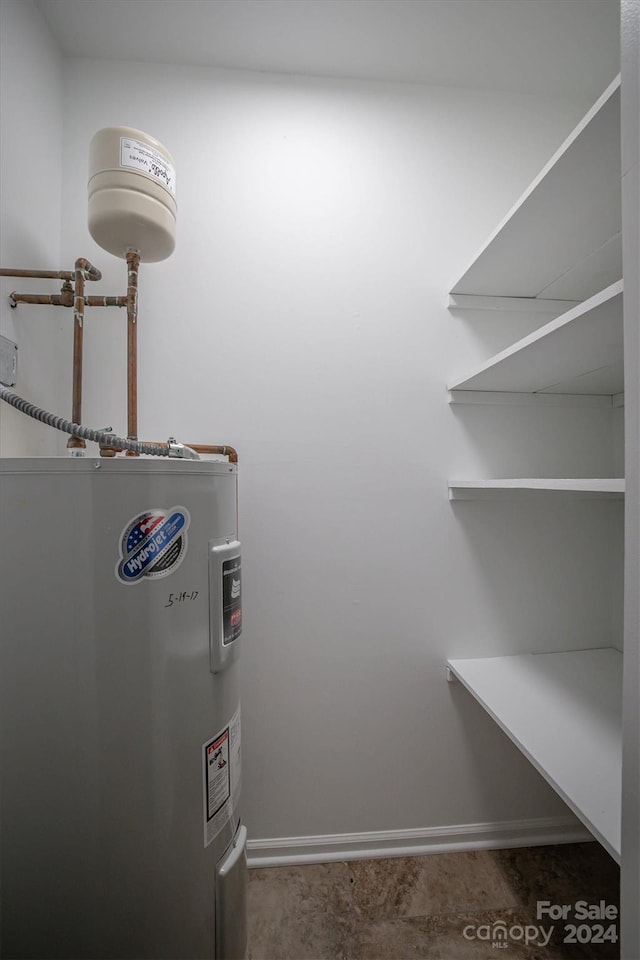 utility room with electric water heater