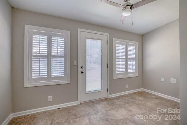 doorway to outside with ceiling fan