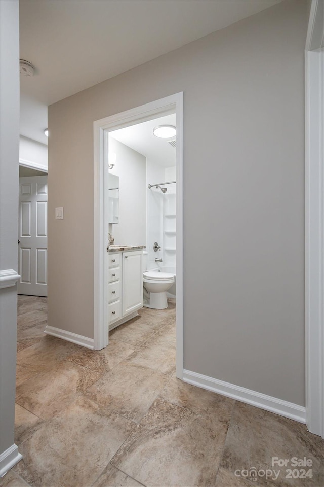 full bathroom with toilet, vanity, and washtub / shower combination