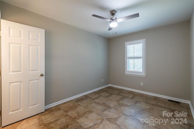 spare room with ceiling fan