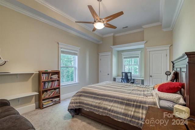 carpeted bedroom with ceiling fan and ornamental molding