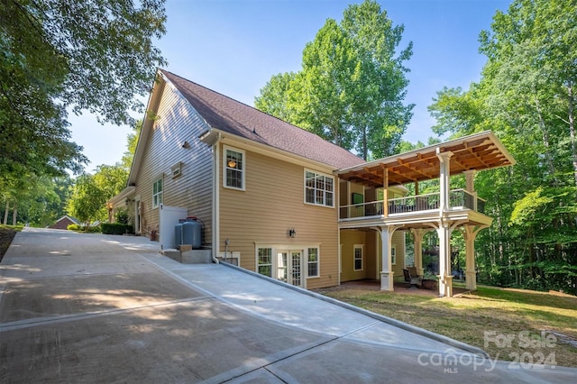 rear view of house with a patio area and a balcony