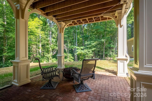 view of patio with a fire pit