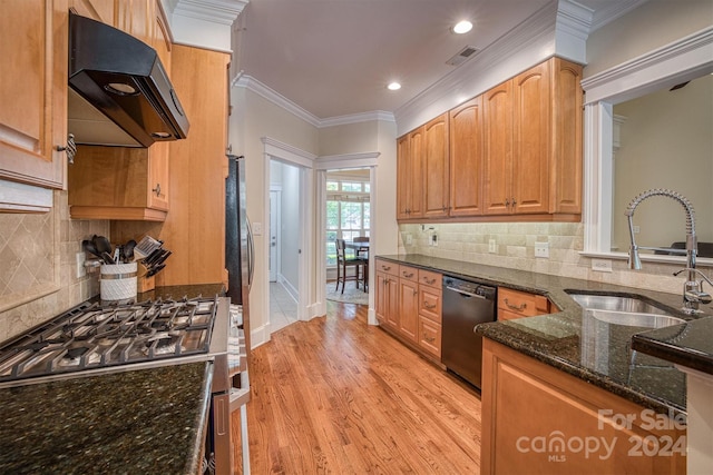 kitchen with sink, stainless steel gas range, black dishwasher, range hood, and dark stone counters