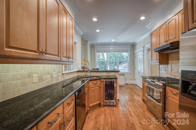 kitchen featuring sink, wine cooler, light hardwood / wood-style flooring, dark stone countertops, and stainless steel appliances