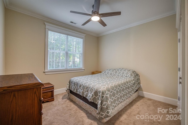 carpeted bedroom featuring ceiling fan and crown molding