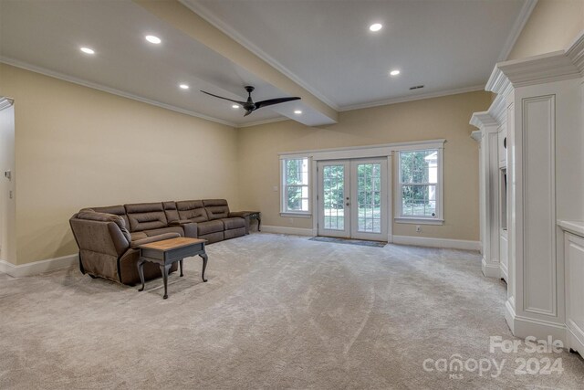 carpeted living room featuring beamed ceiling, ceiling fan, crown molding, and french doors