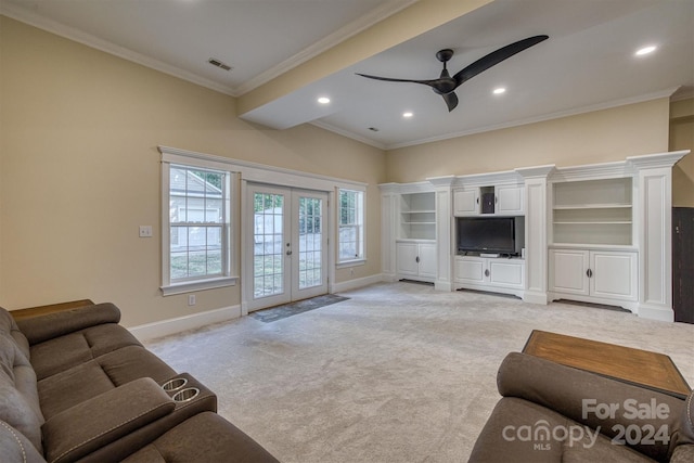 living room with ceiling fan, crown molding, light carpet, and french doors