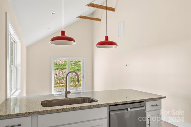 kitchen with sink, vaulted ceiling, stainless steel dishwasher, decorative light fixtures, and white cabinetry